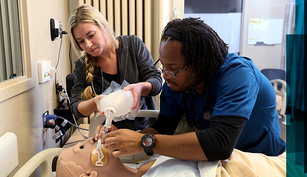 Respiratory care students work in JCCC's simulation lab. 
